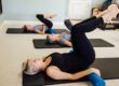 women doing pilates on exercise mats